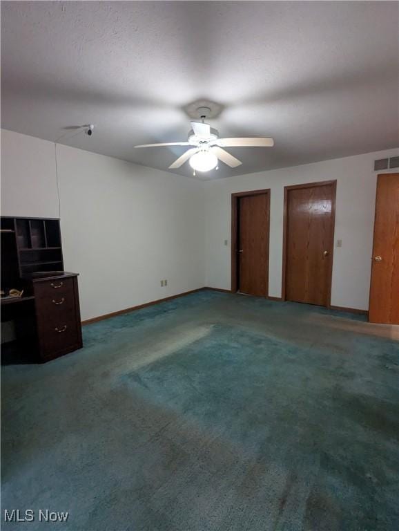 unfurnished bedroom with multiple closets, carpet flooring, and ceiling fan