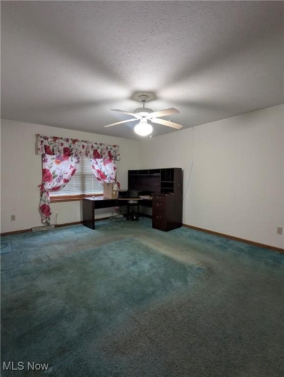 unfurnished office with ceiling fan, carpet flooring, and a textured ceiling