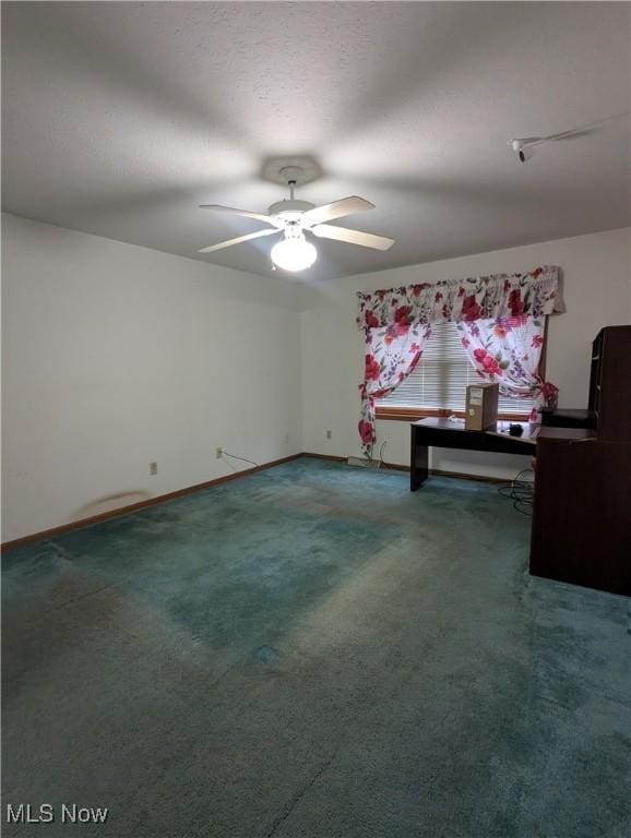 spare room with carpet flooring, a textured ceiling, and ceiling fan