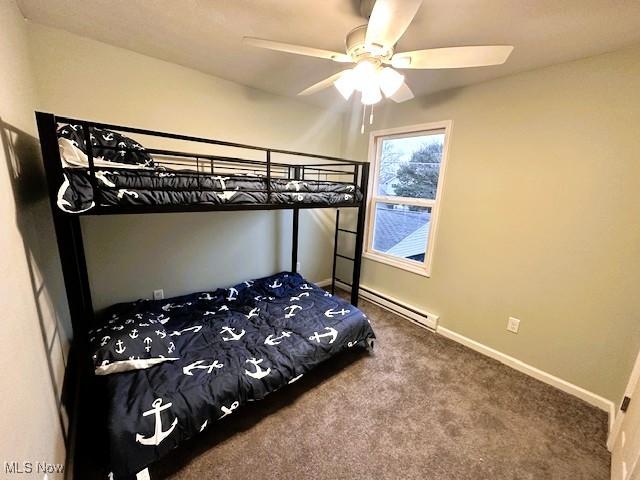 bedroom featuring ceiling fan, carpet flooring, and a baseboard heating unit