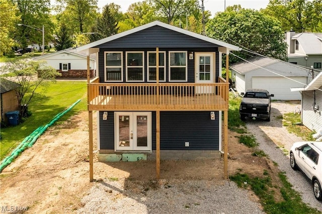 view of front of property featuring a garage and french doors