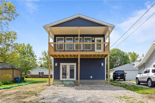 back of property with a balcony