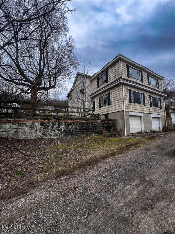 view of side of home featuring a garage