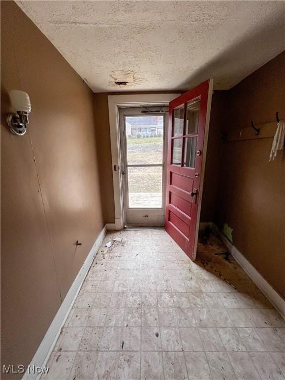 doorway with a textured ceiling