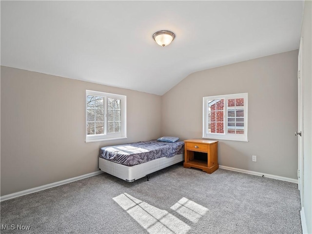 carpeted bedroom featuring lofted ceiling