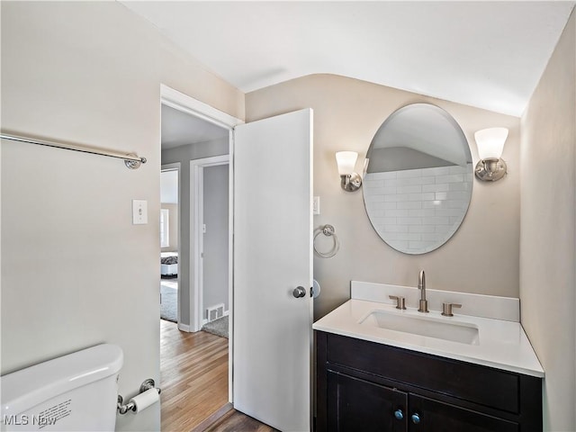 bathroom featuring vanity, toilet, and hardwood / wood-style floors