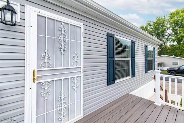 doorway to property featuring a wooden deck