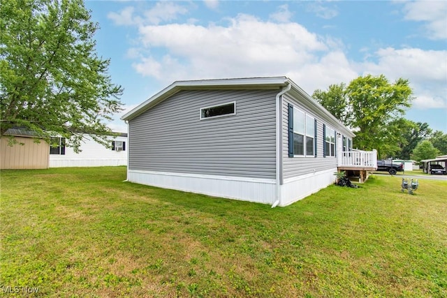 view of property exterior featuring a wooden deck and a lawn