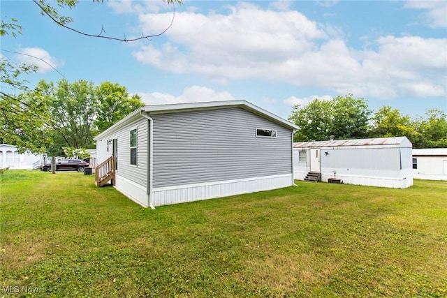 view of side of property with a lawn