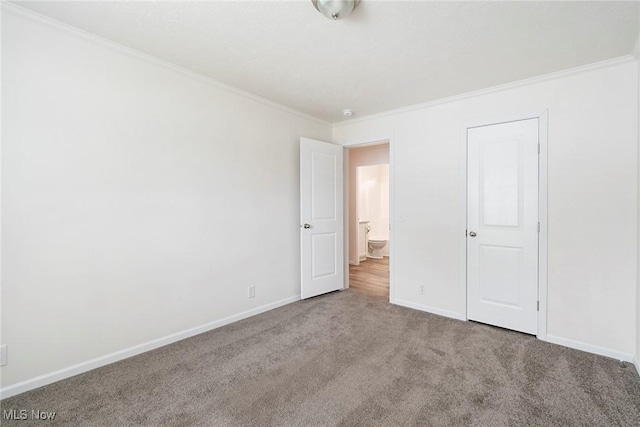 unfurnished bedroom featuring crown molding and light colored carpet