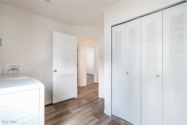 laundry room featuring crown molding, washer / dryer, and hardwood / wood-style flooring