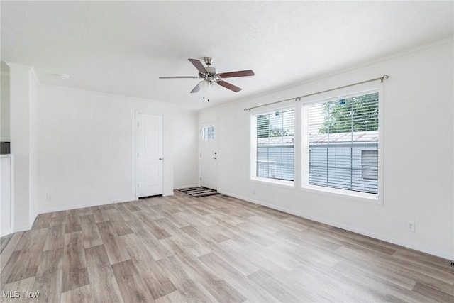 spare room featuring ceiling fan, ornamental molding, and light hardwood / wood-style flooring