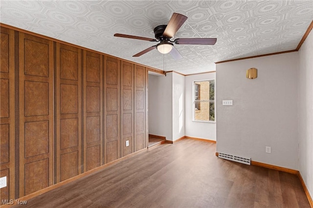 unfurnished bedroom with crown molding, light hardwood / wood-style floors, and ceiling fan