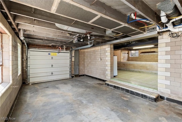 garage featuring a garage door opener and water heater