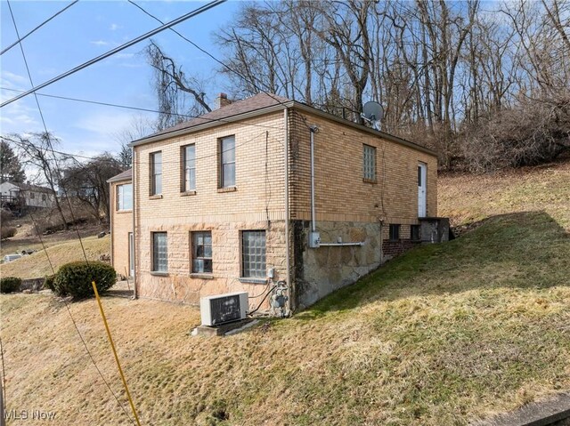 view of property exterior featuring a yard and central air condition unit