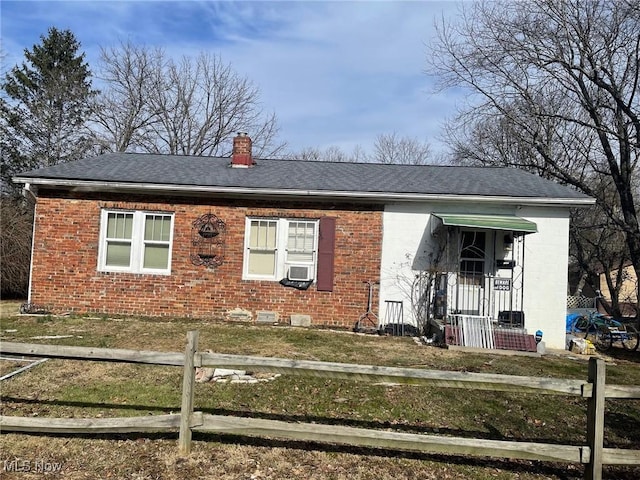 view of front of house featuring cooling unit and a front yard