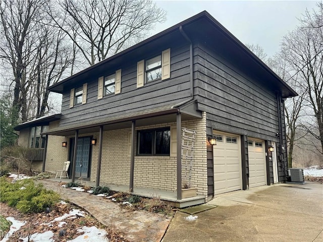 view of front of house featuring a garage and central air condition unit