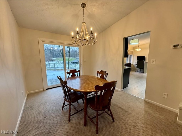 dining space featuring lofted ceiling, light carpet, a textured ceiling, and a chandelier