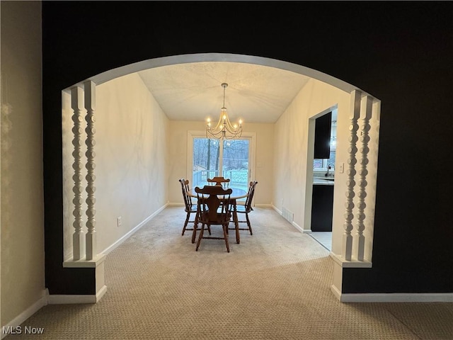 unfurnished dining area featuring an inviting chandelier and light carpet