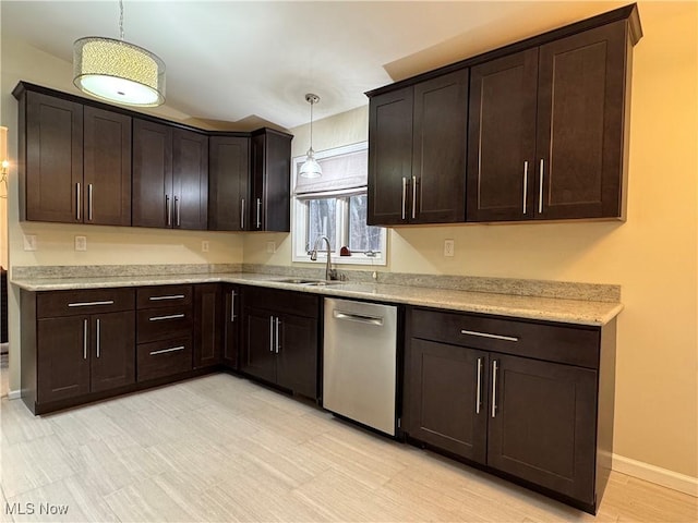 kitchen with pendant lighting, sink, dark brown cabinets, light stone countertops, and stainless steel dishwasher