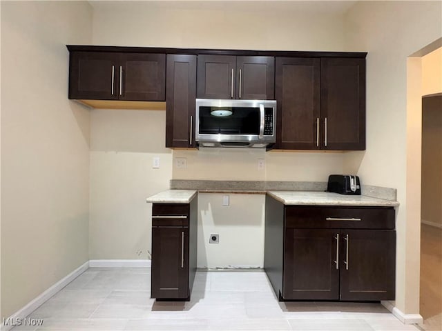 kitchen featuring dark brown cabinetry