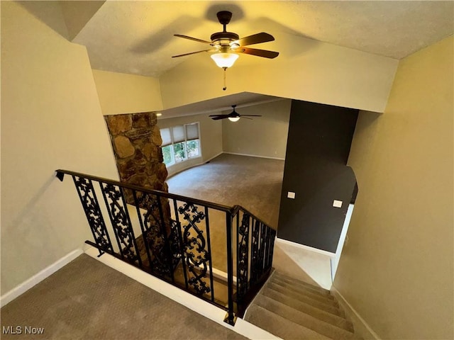 staircase with carpet and lofted ceiling