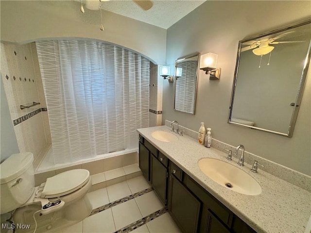 bathroom with tile patterned floors, toilet, a textured ceiling, vanity, and ceiling fan