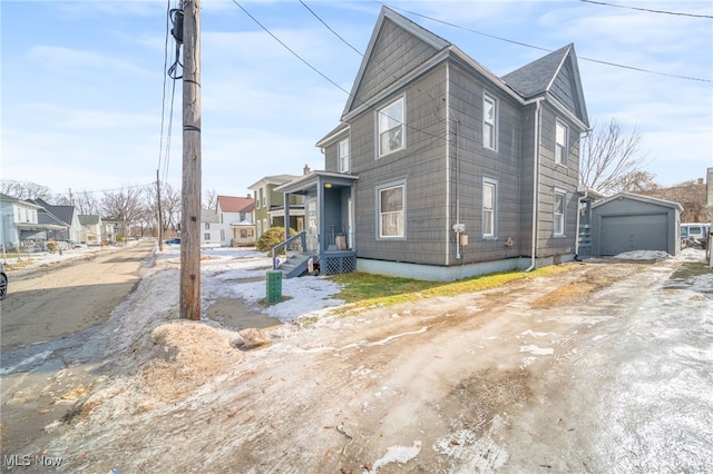 view of side of property featuring a garage and an outdoor structure