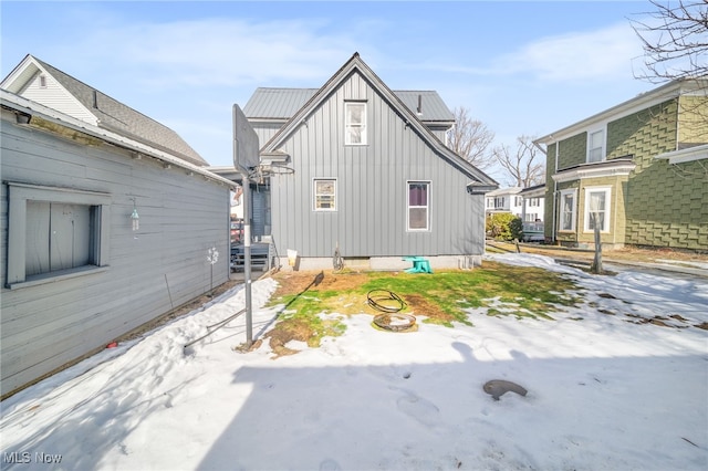 view of side of property with a fire pit