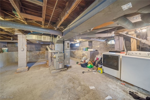 basement featuring washer and dryer and heating unit