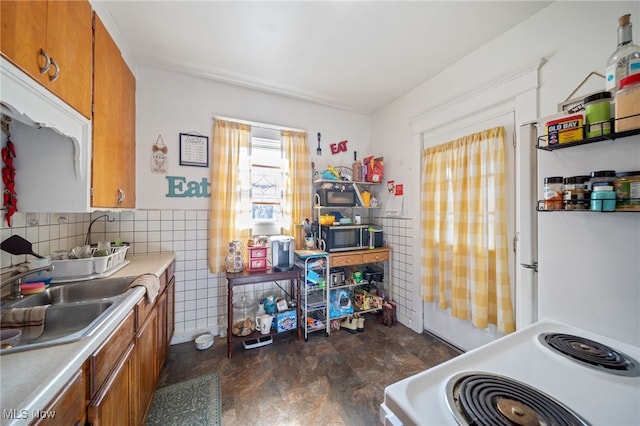 kitchen featuring sink, tile walls, and electric range