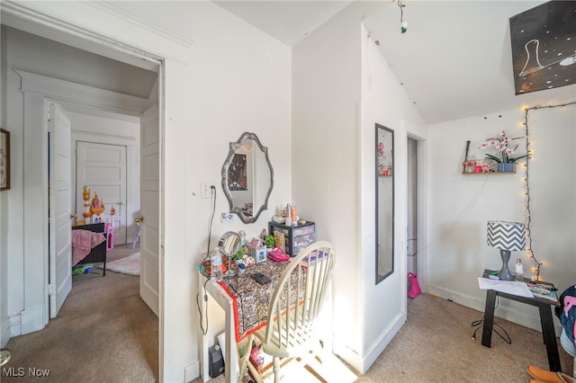 hallway with lofted ceiling and carpet flooring