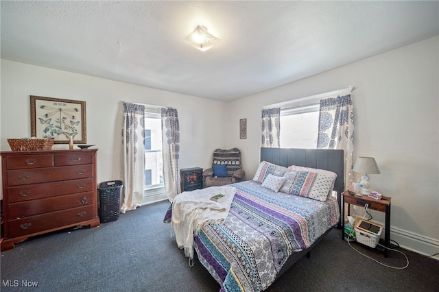 carpeted bedroom with a textured ceiling