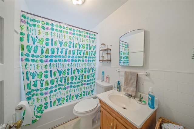 full bathroom with vanity, tile walls, shower / tub combo, and toilet