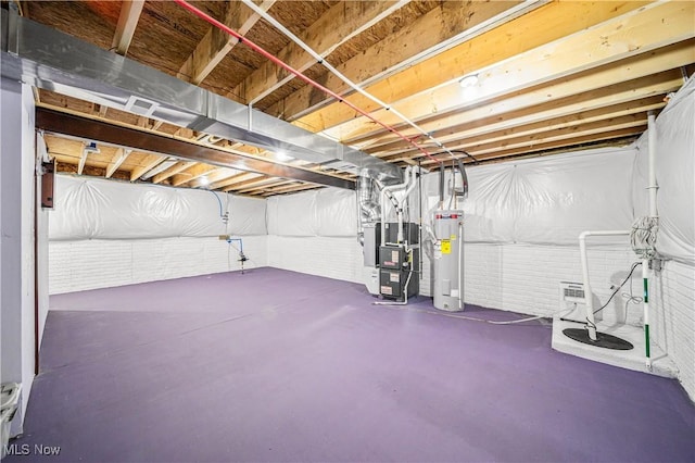 basement featuring electric water heater and heating unit