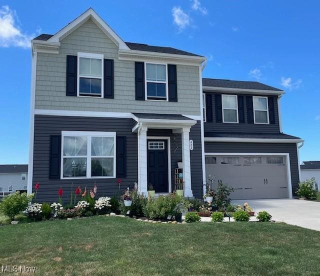 view of front of house featuring a garage and a front yard