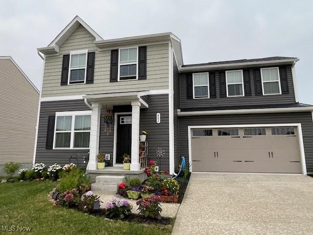 view of front facade with a garage and a front lawn