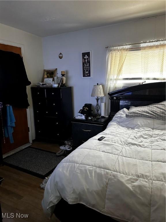 bedroom with hardwood / wood-style flooring