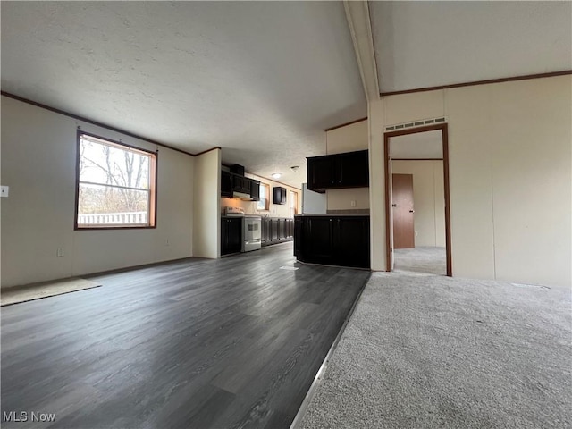 unfurnished living room featuring ornamental molding and dark hardwood / wood-style floors