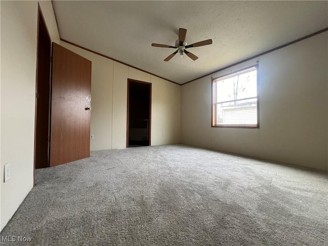 unfurnished bedroom featuring crown molding, ceiling fan, carpet floors, and a textured ceiling