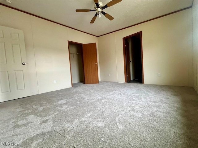 unfurnished bedroom with crown molding, carpet floors, and a closet