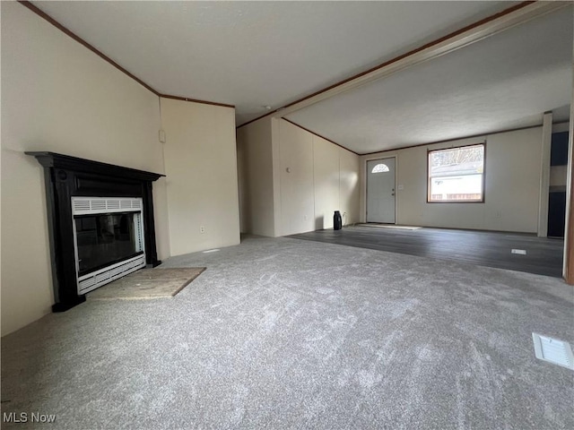 unfurnished living room with lofted ceiling and carpet flooring