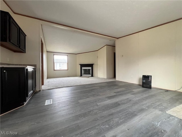 unfurnished living room with hardwood / wood-style floors and ornamental molding