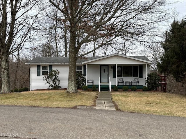 single story home with covered porch and a front yard