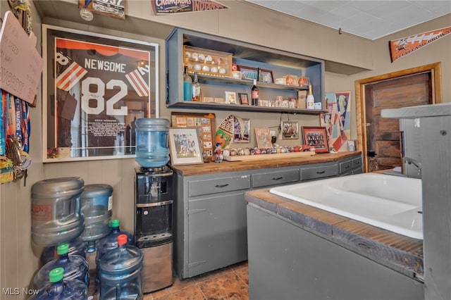 laundry area with light tile patterned floors