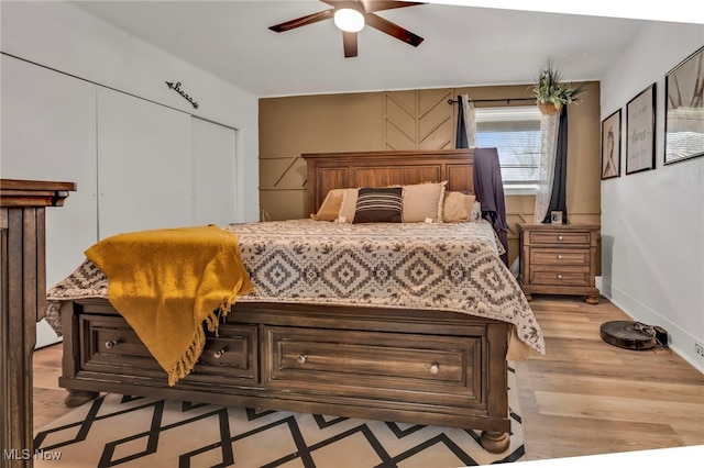 bedroom with light hardwood / wood-style floors and a closet