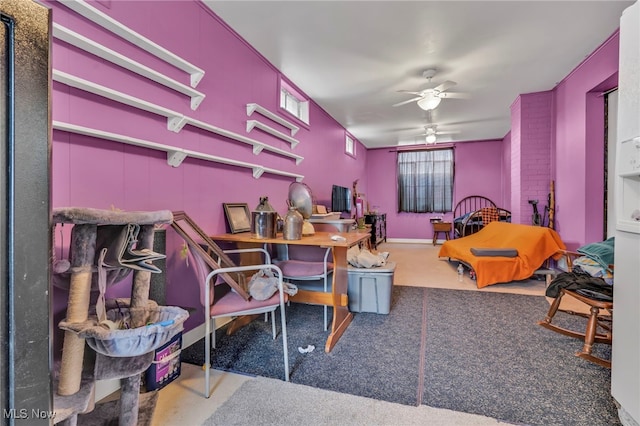 carpeted office space featuring ceiling fan