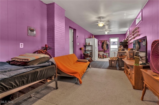 carpeted bedroom with a spacious closet, ceiling fan, and a closet