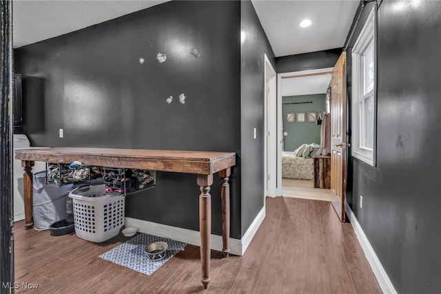 hallway with hardwood / wood-style flooring