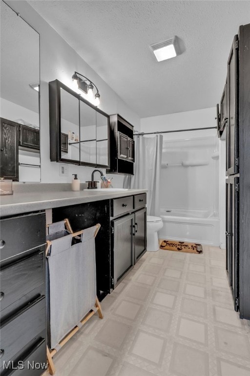 kitchen featuring sink and a textured ceiling